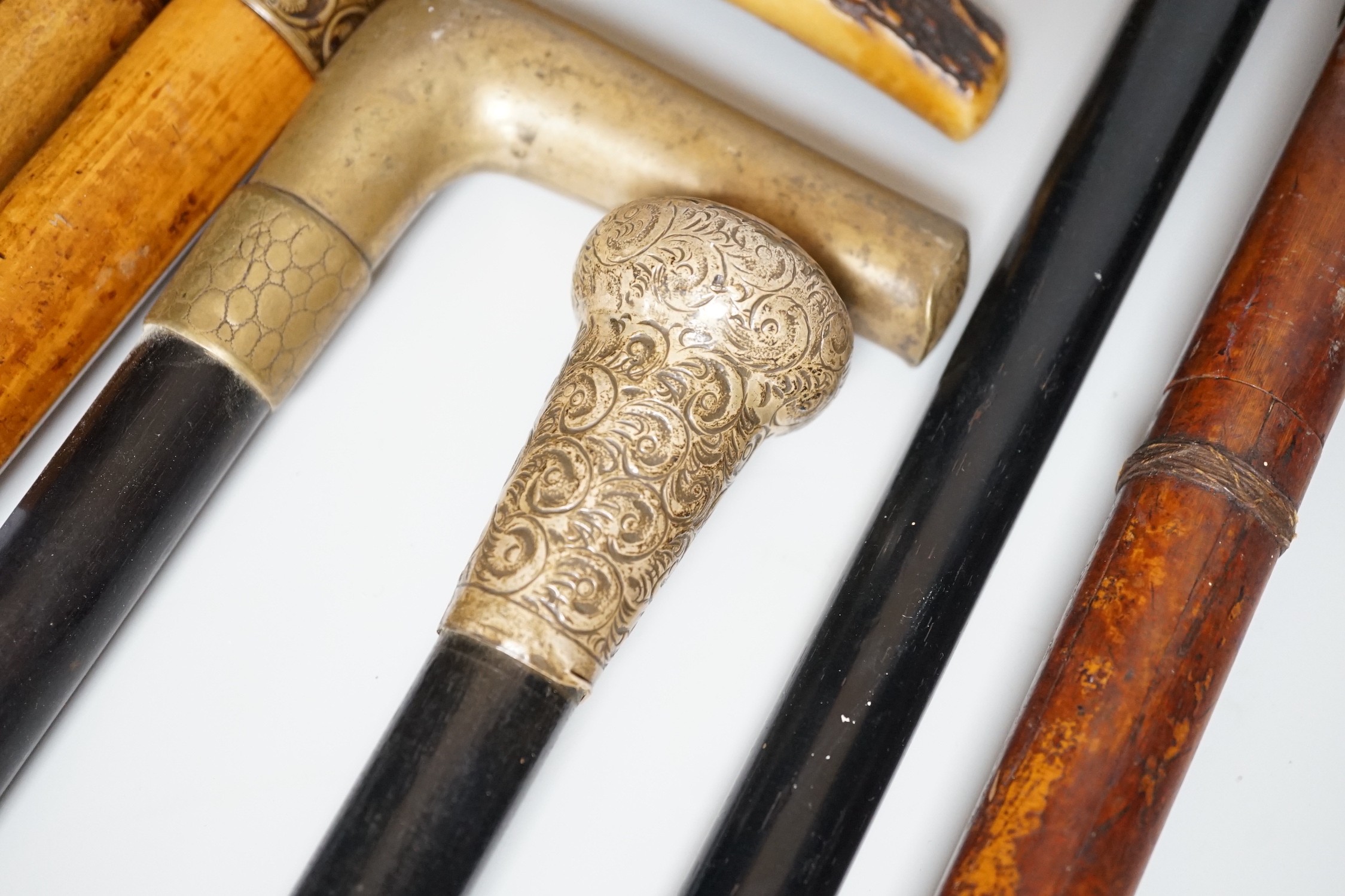 Two Victorian silver mounted walking sticks, a sword stick and three other sticks (6)